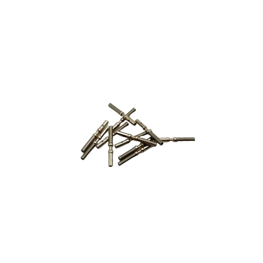 A small pile of metallic cylindrical pins or rods with a warm metallic finish, scattered on a plain light background.